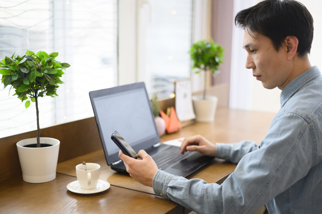 high-angle-man-with-laptop-mobile